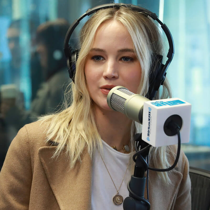 Jennifer Lawrence behind the microphone being interviewed on SiriusXM's Radio Andy channel.
