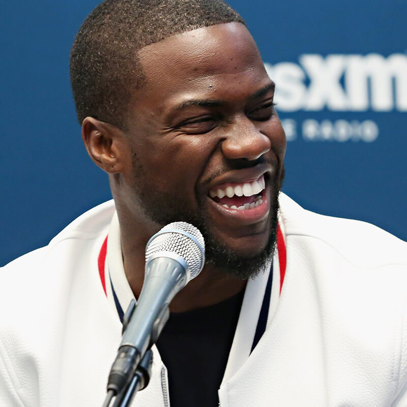 Kevin Hart laughing while broadcasting live on SiriusXM's Kevin Hart's Laugh Out Loud Radio channel.