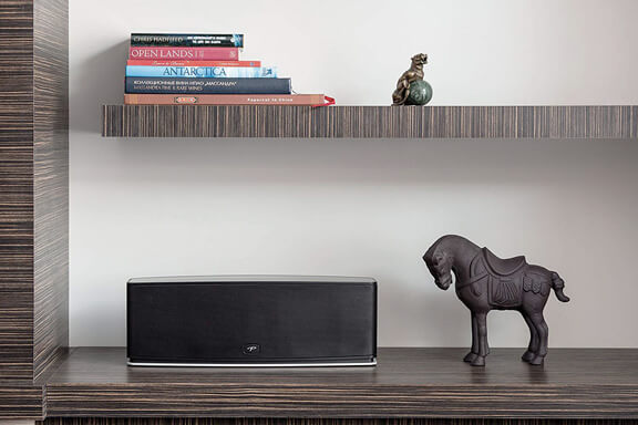 A DTS Play-Fi platform on a shelf beside a wooden horse.
