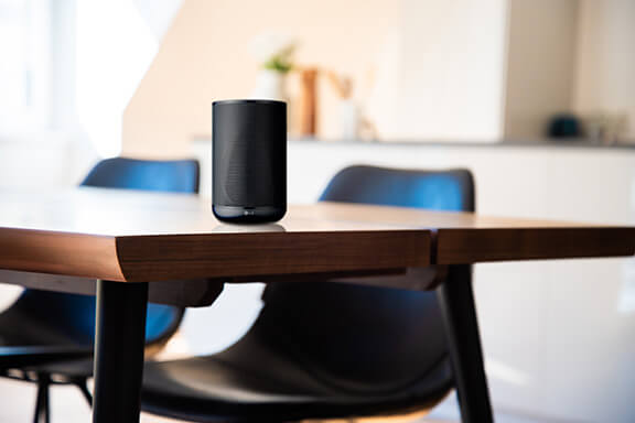 A speaker on a coffee table.