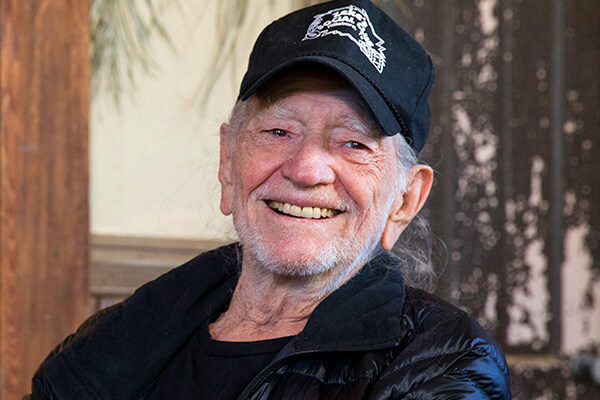 An image of Willie Nelson smiling.