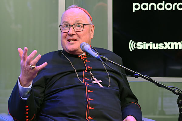 An image of Cardinal Dolan in front of a microphone.