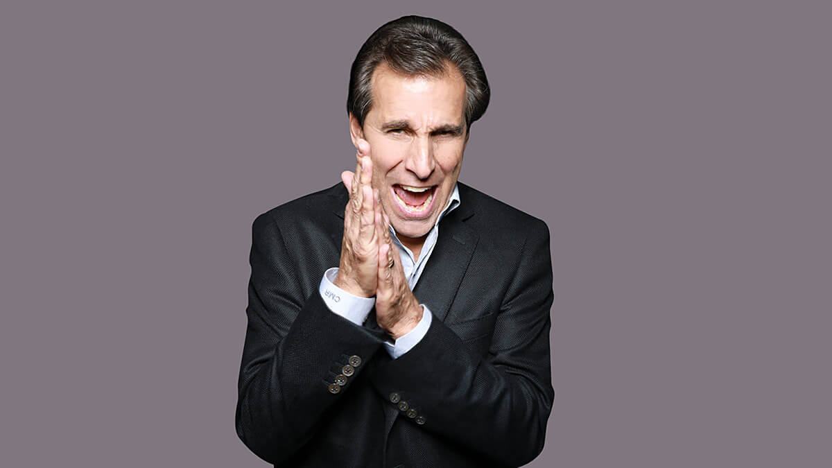 An image of Chris 'Mad Dog' Russo with his hands together.