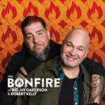 Big Jay Oakerson & Robert Kelly, one with a beard and the other bald, smile and pose together in front of an orange background with stylized flame patterns. Text at the bottom reads: The Bonfire with Big Jay Oakerson & Robert Kelly—Listen to the Bonfire podcast on SiriusXM.