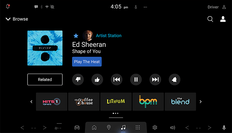 A SiriusXM infotainment screen for Mazda displays Ed Sheeran’s Shape of You playing on an artist station, with album art, playback controls, and music app icons such as Hits 1, The Coffee House, Lithium, and The Blend below.