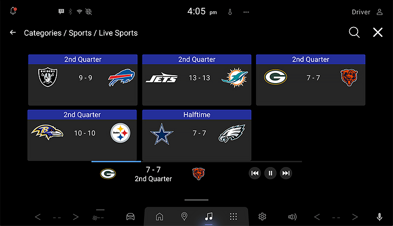 A SiriusXM infotainment screen for Mazda displays live NFL scores: Raiders 9-9 Bills, Jets 13-13 Dolphins, Packers 7-7 Bears, Ravens 10-10 Steelers (2nd quarter), and Cowboys 7-7 Eagles (halftime).