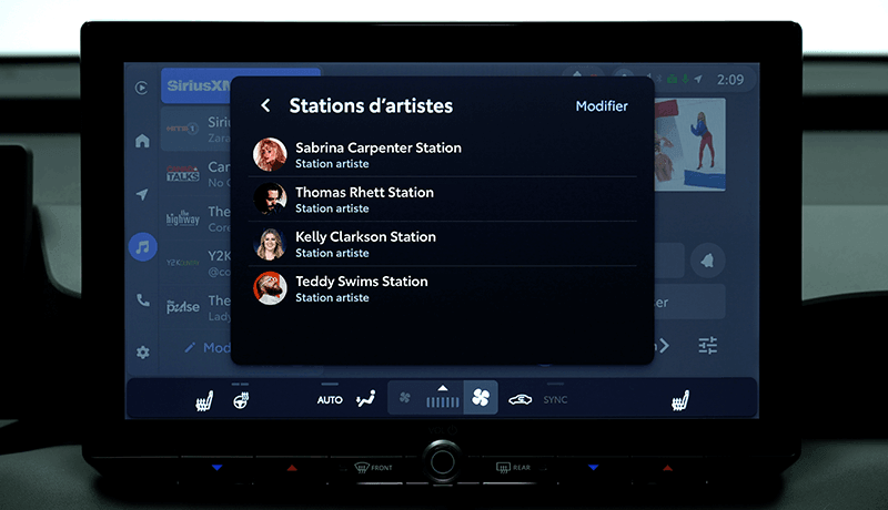 Un écran d'infodivertissement SiriusXM pour Toyota avec 360L affiche une application musicale avec une liste de stations d'artistes, dont Sabrina Carpenter, Thomas Rhett, Kelly Clarkson et Teddy Swims. L'interface en arrière-plan comporte diverses icônes et un logo SiriusXM.