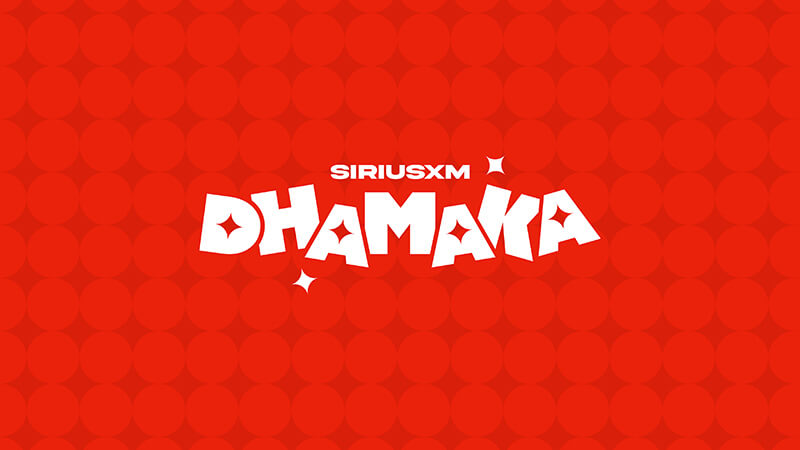 White text reading SiriusXM Dhamaka in bold, playful font is centred on a red background with a pattern of circular shapes and two white star accents. Listen to SiriusXM Dhamaka on SiriusXM.