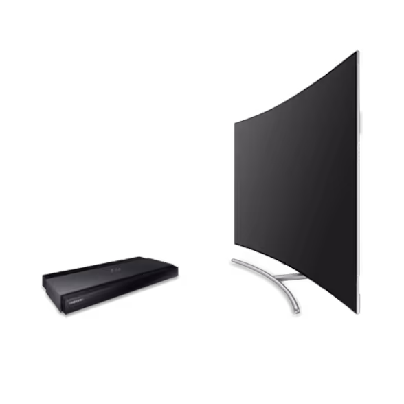 A curved flat-screen Sumsung TV on a silver stand is next to a black electronic device, possibly a Blu-ray or media player, with a Google Nest Mini nearby