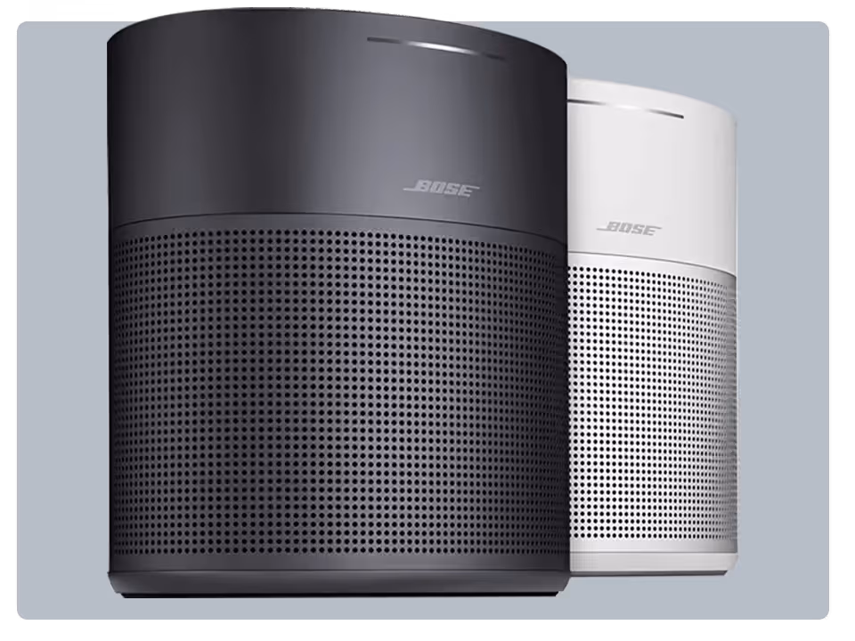 Two Bose Speakers, one black and one white, stand side by side—perfect for elevating your listening experience when paired with the SiriusXM app.
