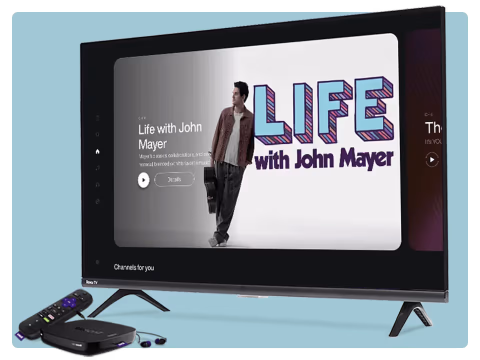 A TV displays a show titled Life with John Mayer. A man stands beside large text. In front of the TV are a remote, a streaming device, and purple earbuds, all on a light blue background.